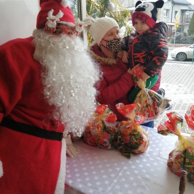 Św. Mikołaj wręcza paczkę dziecku z Mierzowic